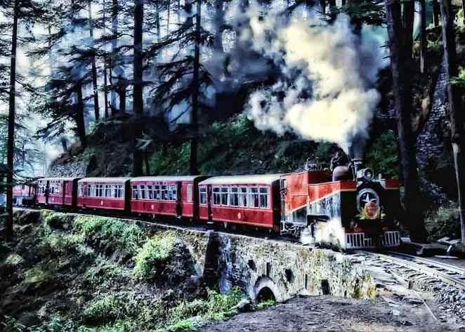 Beautiful train journey through forested hills with a vintage steam train on a scenic railway track