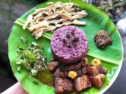 Traditional Naga meal served on banana leaf with purple rice and local delicacies on Hornbill Festival